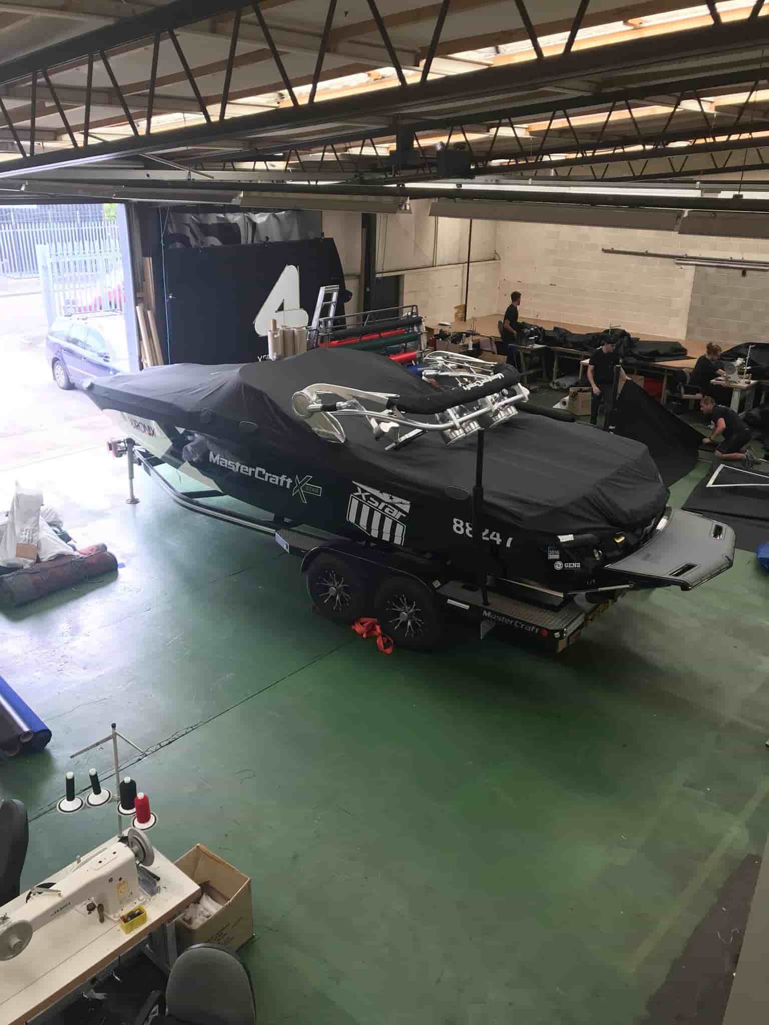 Made-to-measure tarpaulins and covers for boat in manufacturing facilty for J Clemishaw 1870 Ltd in Bury