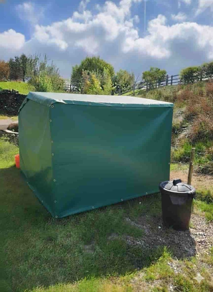 Green PVC equipment cover installed outdoors